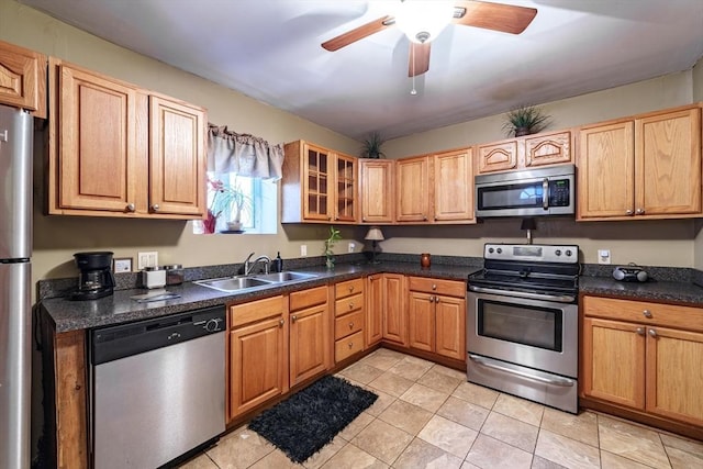 kitchen with sink, light tile patterned floors, ceiling fan, and appliances with stainless steel finishes