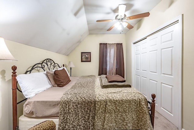 carpeted bedroom with ceiling fan, lofted ceiling, and a closet