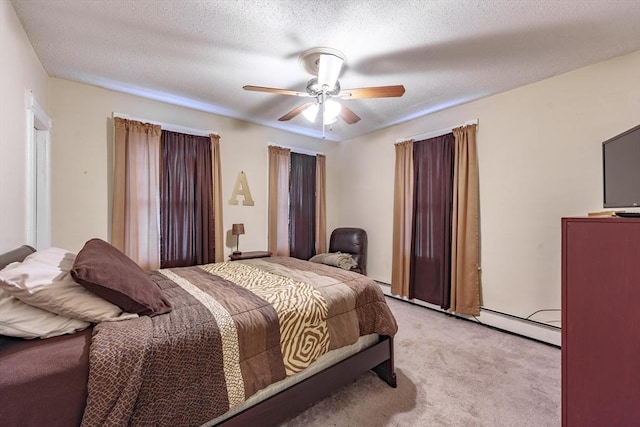 bedroom featuring ceiling fan, light carpet, and a textured ceiling