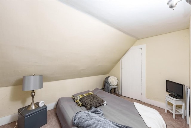 carpeted bedroom featuring lofted ceiling