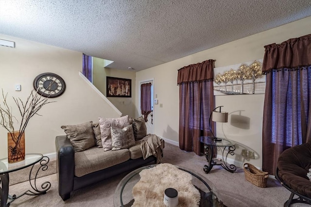 living room featuring carpet and a textured ceiling