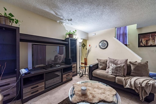 carpeted living room featuring a textured ceiling