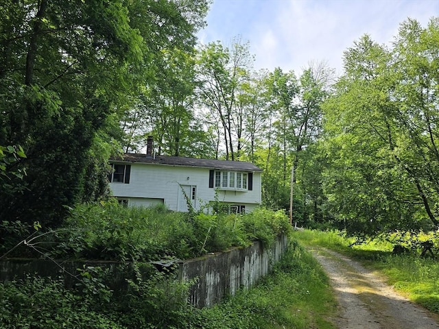 35 Beacon St, Orange, MA 01364 - bi-level home with a chimney and driveway