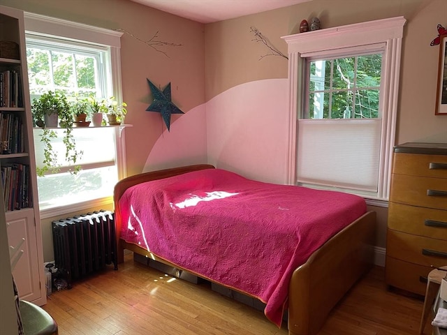 75 Rossmore Rd Unit 5, Boston, MA 02130 - bedroom with radiator heating unit and hardwood / wood-style floors