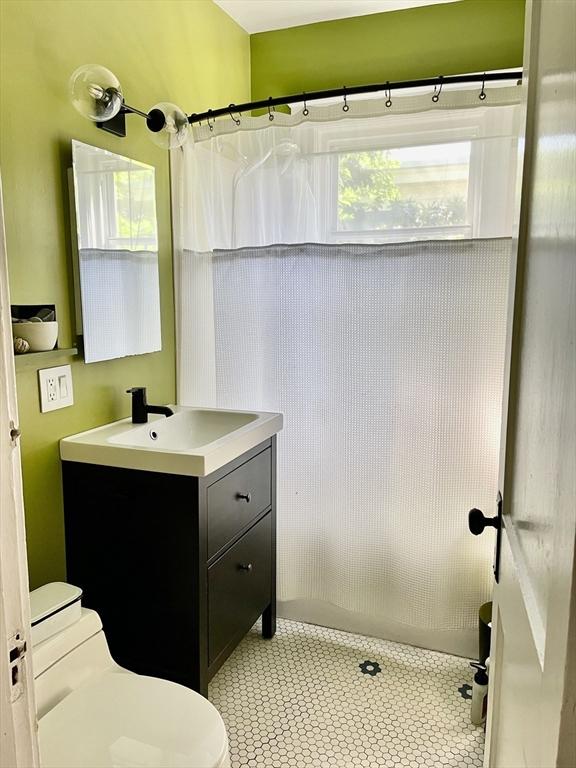 75 Rossmore Rd Unit 5, Boston, MA 02130 - bathroom featuring vanity, a shower with curtain, and tile patterned flooring