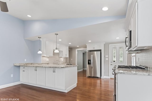 591 Poplar St, Boston, MA 02131 - kitchen featuring appliances with stainless steel finishes, a peninsula, white cabinetry, dark wood-style floors, and recessed lighting