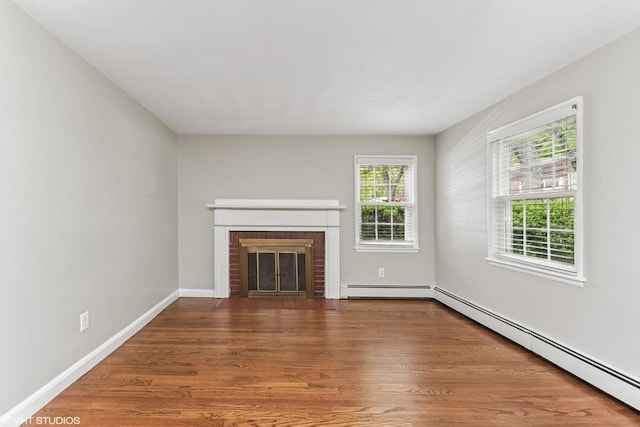 591 Poplar St, Boston, MA 02131 - unfurnished living room featuring baseboard heating, a brick fireplace, wood finished floors, a baseboard heating unit, and baseboards