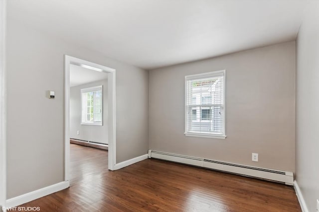 591 Poplar St, Boston, MA 02131 - empty room with baseboard heating, plenty of natural light, and wood finished floors