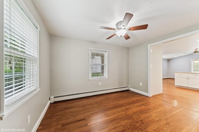 591 Poplar St, Boston, MA 02131 - unfurnished room featuring a baseboard radiator, ceiling fan, plenty of natural light, and light wood-style floors