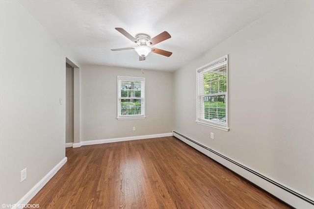 591 Poplar St, Boston, MA 02131 - unfurnished room featuring baseboard heating, plenty of natural light, wood finished floors, and ceiling fan