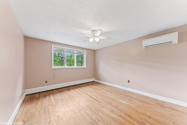 591 Poplar St, Boston, MA 02131 - spare room with a wall unit AC, light wood-style floors, baseboards, and a ceiling fan