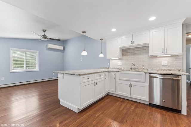 591 Poplar St, Boston, MA 02131 - kitchen with stainless steel dishwasher, a peninsula, a baseboard radiator, dark wood-style flooring, and decorative backsplash
