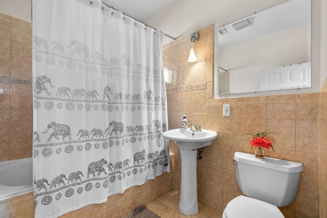 41 Standish St Unit 3, Boston, MA 02124 - bathroom featuring tile walls, tiled shower / bath, toilet, and a sink