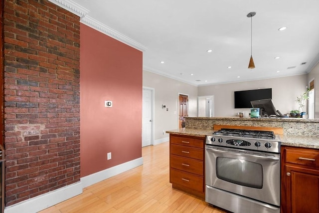 41 Standish St Unit 3, Boston, MA 02124 - kitchen with stainless steel gas range oven, light wood finished floors, baseboards, light stone counters, and brown cabinetry