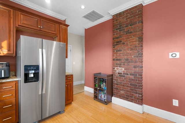 41 Standish St Unit 3, Boston, MA 02124 - kitchen featuring stainless steel fridge, baseboards, light wood-style floors, brown cabinets, and crown molding