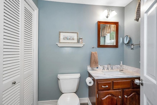 718 Wellman Ave Unit 718, Chelmsford, MA 01863 - half bathroom with a closet, vanity, toilet, and baseboards
