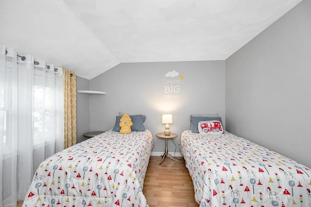 718 Wellman Ave Unit 718, Chelmsford, MA 01863 - bedroom featuring wood finished floors and lofted ceiling