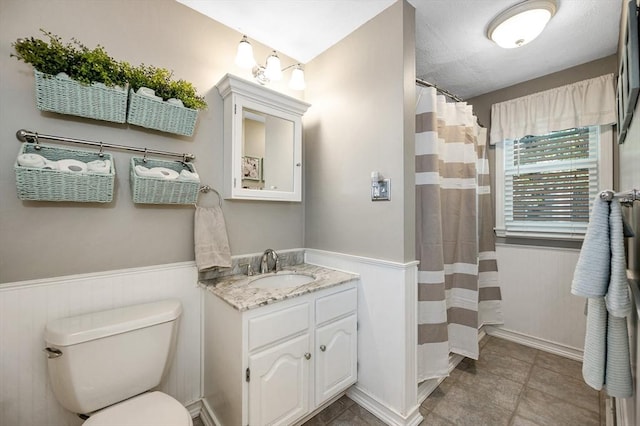 718 Wellman Ave Unit 718, Chelmsford, MA 01863 - full bathroom with vanity, wainscoting, toilet, and a shower with curtain