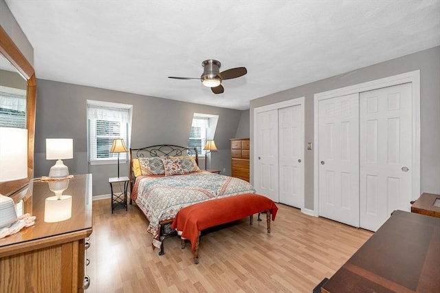 718 Wellman Ave Unit 718, Chelmsford, MA 01863 - bedroom with two closets, light wood-style flooring, baseboards, and ceiling fan