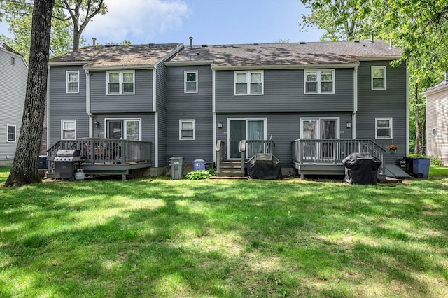 718 Wellman Ave Unit 718, Chelmsford, MA 01863 - rear view of house with a deck and a lawn
