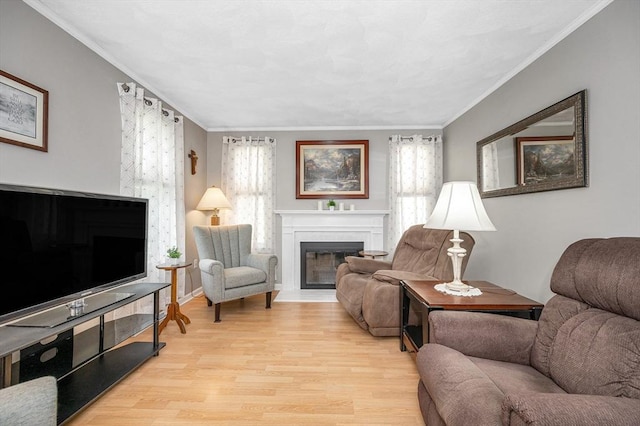 718 Wellman Ave Unit 718, Chelmsford, MA 01863 - living area with healthy amount of natural light, a fireplace with flush hearth, wood finished floors, and crown molding