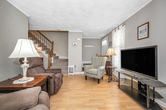 718 Wellman Ave Unit 718, Chelmsford, MA 01863 - living room with wood finished floors, stairway, crown molding, and baseboards