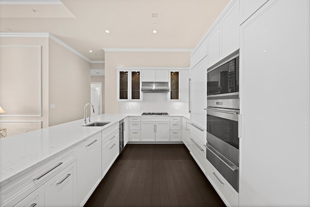 kitchen featuring dark hardwood / wood-style floors, white cabinets, sink, and black microwave