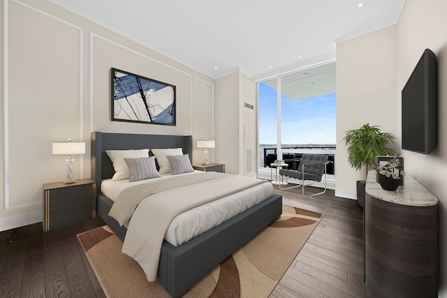 bedroom with expansive windows, dark hardwood / wood-style floors, and ornamental molding