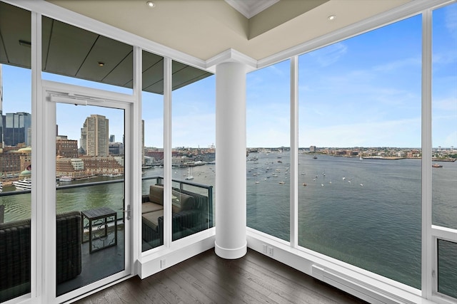 unfurnished sunroom featuring a water view