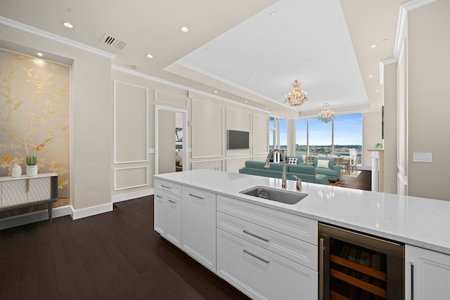 kitchen with white cabinetry, a tray ceiling, sink, wine cooler, and dark hardwood / wood-style flooring