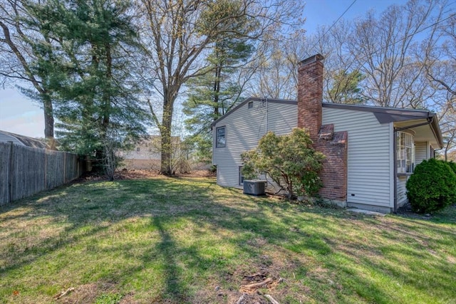 view of yard featuring fence and cooling unit