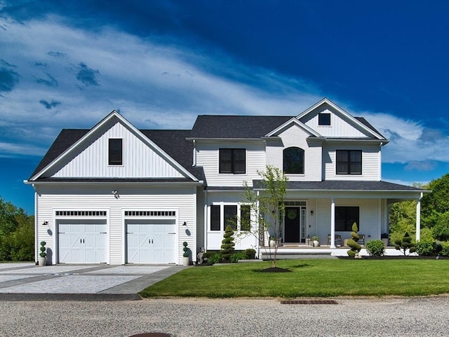 50 Bentley Ln, Westport, MA 02790 - view of front of house with covered porch, a front yard, board and batten siding, and concrete driveway