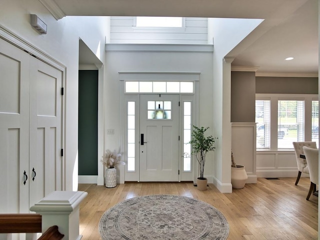 50 Bentley Ln, Westport, MA 02790 - entrance foyer featuring light wood-style flooring, crown molding, and a decorative wall