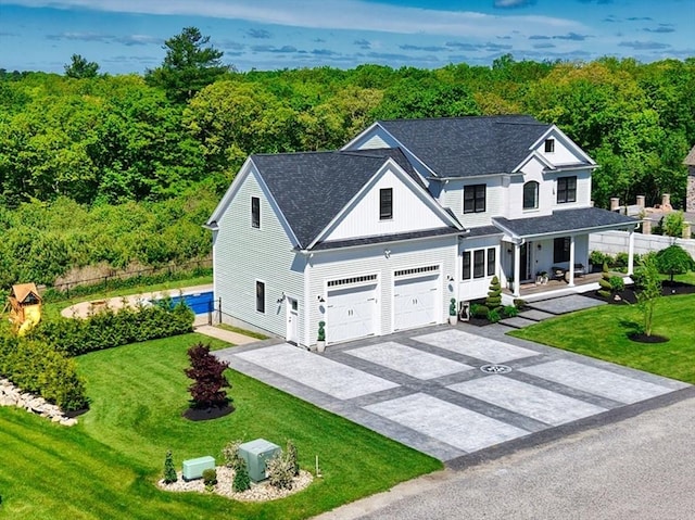 50 Bentley Ln, Westport, MA 02790 - view of front of house with asphalt driveway, a porch, roof with shingles, and a wooded view