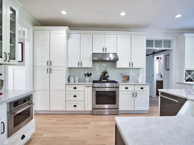 50 Bentley Ln, Westport, MA 02790 - kitchen with stainless steel appliances, under cabinet range hood, crown molding, white cabinetry, and recessed lighting