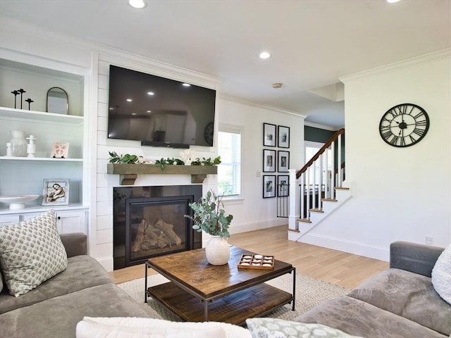 50 Bentley Ln, Westport, MA 02790 - living room with ornamental molding, stairs, light wood-style floors, baseboards, and a large fireplace