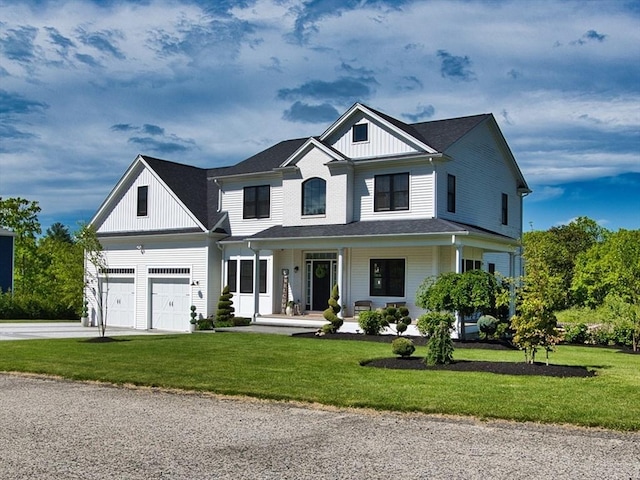 50 Bentley Ln, Westport, MA 02790 - view of front of house with a porch, driveway, board and batten siding, and a front lawn