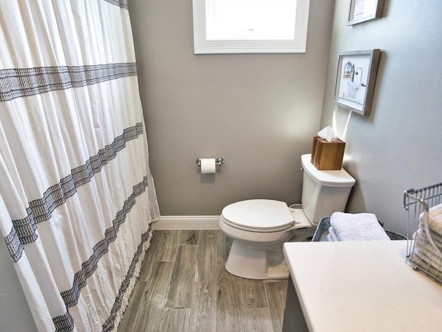 50 Bentley Ln, Westport, MA 02790 - full bathroom featuring wood finished floors, toilet, baseboards, and a shower with shower curtain