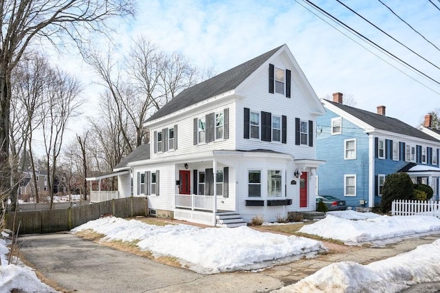 view of front of house featuring fence and a porch