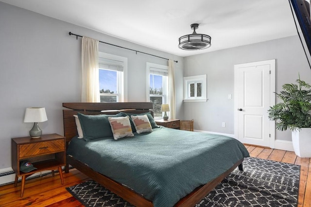 bedroom featuring hardwood / wood-style flooring and baseboards