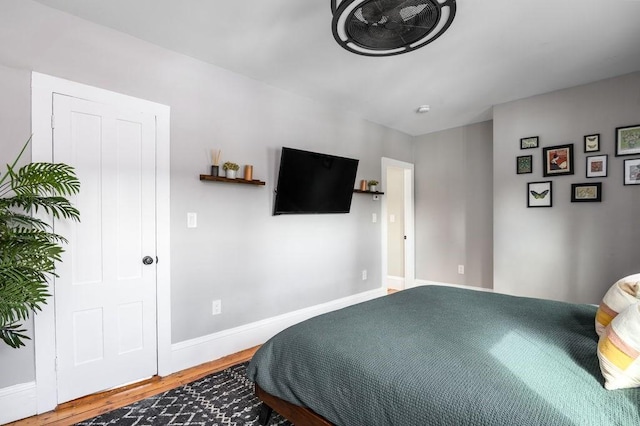 bedroom with baseboards and wood finished floors