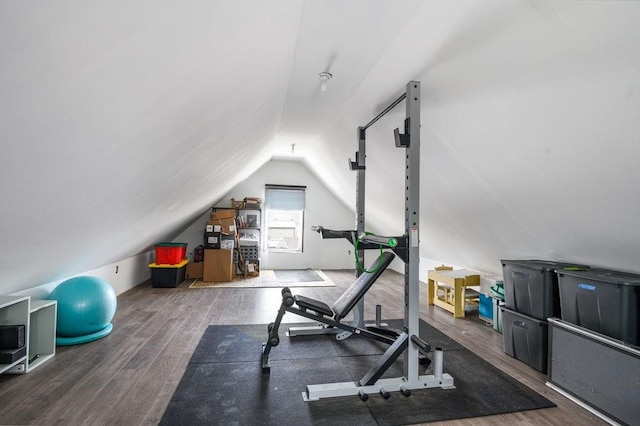 exercise area featuring vaulted ceiling and wood finished floors