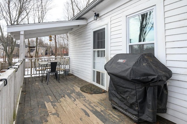 wooden deck featuring outdoor dining area and grilling area