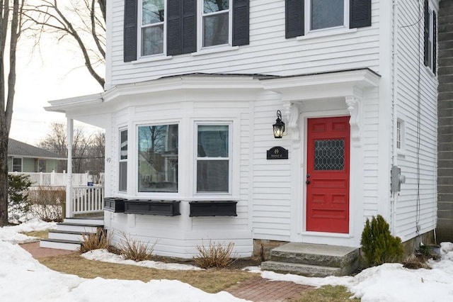 view of snow covered property entrance