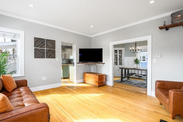 living room featuring crown molding and light wood finished floors