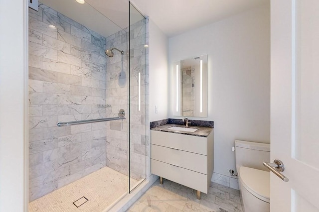 bathroom featuring marble finish flooring, a stall shower, toilet, and vanity