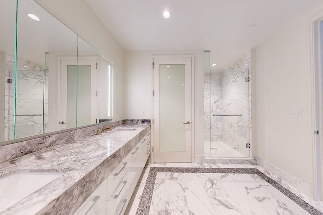 full bathroom featuring marble tiled floors, a marble finish shower, recessed lighting, and double vanity