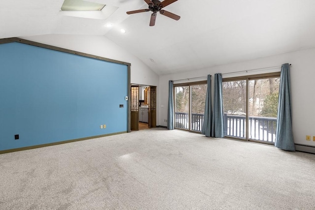 carpeted spare room featuring ceiling fan and high vaulted ceiling