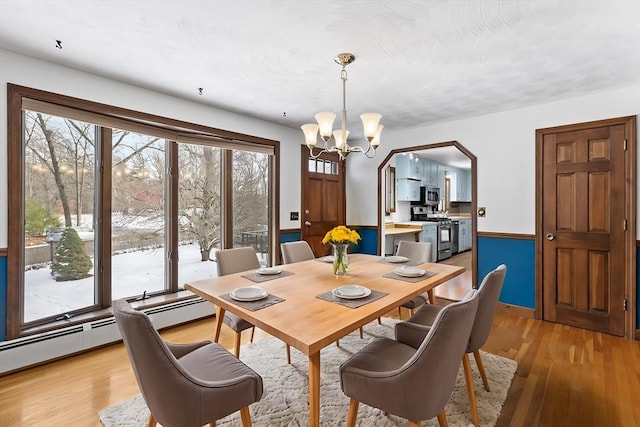 dining space featuring a chandelier and light wood-type flooring