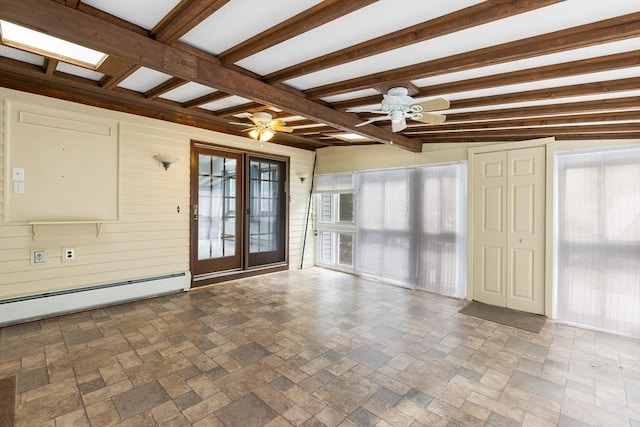 empty room with beamed ceiling, ceiling fan, wooden walls, and baseboard heating